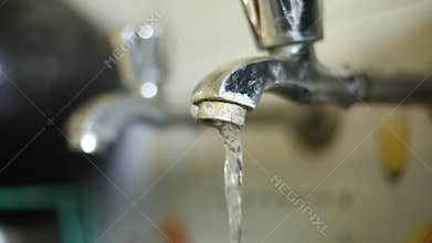 Water Driping From The Tap Into A Sink