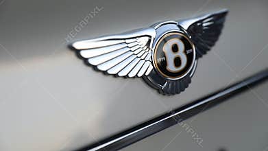 Close up of chrome Bentley badge on white car