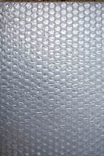 Plastic Bubble Cushioning Wrap surface texture on white background, Close up shot, Transparent wrapping concept