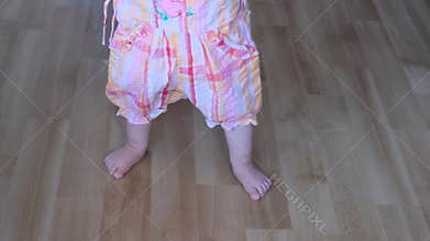 Baby does walks at home, the concept of the first steps, happy childhood, children`s games, alpha generation