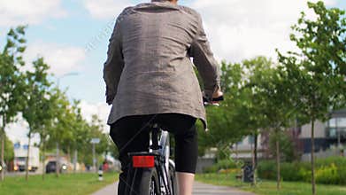 Young man riding bicycle on city street