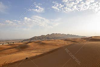 Mleiha Sand dune, deserts of Sharjah, with gold sand and blue sky