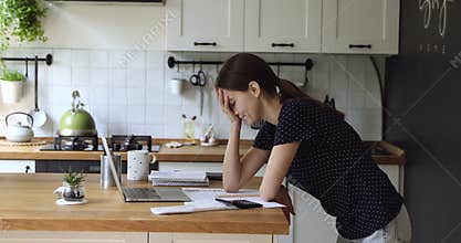 Woman makes expense and earnings analysis feels tired and disappointed