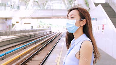 Business woman wearing face mask at train station