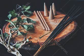 Examples of various types of incense - long black sticks, short hand made sticks and  small triangular cones