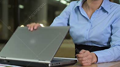Exhausted office worker closing laptop and falling asleep on table, overtime