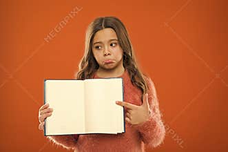 Sad news. Girl hold book orange background. Child show open pages of book or notepad. Book store concept. Free books