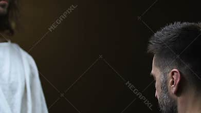 Poor man praying to Jesus Christ against black background, Christianity concept