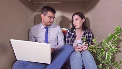 Concept idea of a little room,young married couple huddled in a tight box