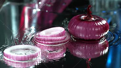 Red onion falls beautifully on the table, Slow Motion,4k, fresh  onion, Water