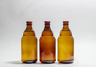 Beer bottles with a red cork on a gray background. Design. Minimalism. Creative idea. Mock-up