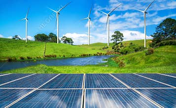 Solar panel and wind turbines farm on green hills