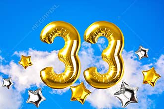 Happy 33 years old party with golden shiny inflatable balloons
