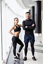 Sport, fitness, lifestyle and people concept - happy sportive man and woman at gym