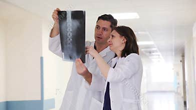 Two Doctors in Clinic`s Corridor