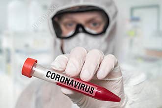 Scientist is holding test-tube on CORONAVIRUS COVID-19