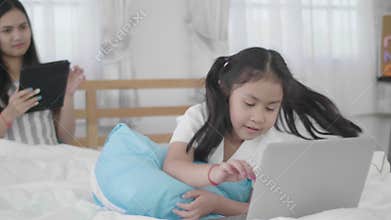 Asian girls and sisters are using laptops, computers and tablets to connect to the cyber world.