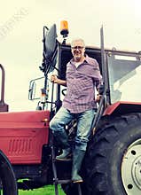 Old man or farmer getting out of tractor at farm