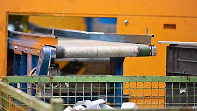 Operator working at Factory conveyor belt. Industrial manufacturing process. Metal stamped pieces production line. Metal