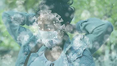 Animation of macro Covid-19 cells floating over Asian woman putting mask on