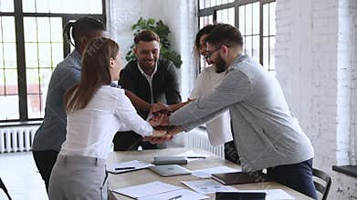 Group of happy young diverse managers building successful team cooperation.