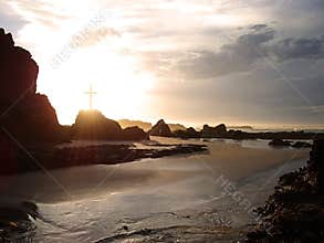 Glowing cross by the sea
