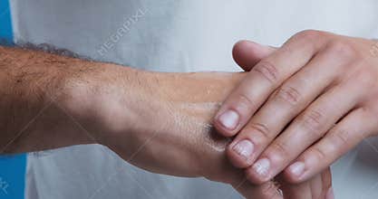 Man applying body lotion on arms for ultra violet protection