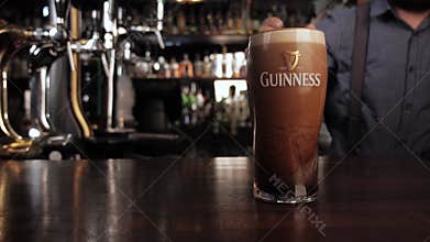 NIZHNY NOVGOROOD, RUSSIA, June 21, 2016 - Bartender puts Guinness on bar
