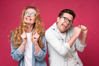 Dancing, moving, having fun. Young and happy man and woman celebrating success.