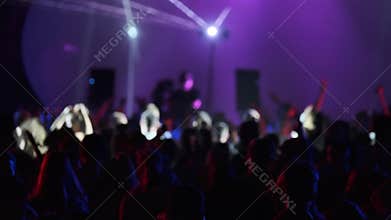 Crowd dancing in dark nightclub