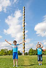 Children in front of The Endless Column or The Column of Infinity