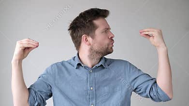 Young stressed man talking to his hands, suffering mental bipolar disorder.