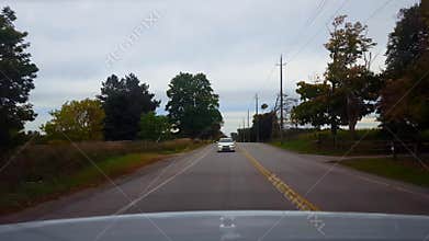 Rear view driving of approaching vehicle getting closer to car. Car point of view of driver driving up to slower car