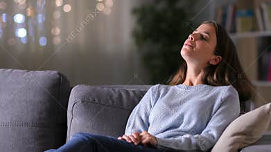 Relaxed woman breathing fresh air at home in the night