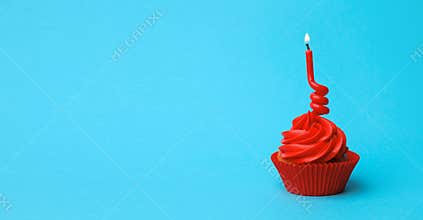 Delicious birthday cupcake with red cream and candle on light blue background. Space for text