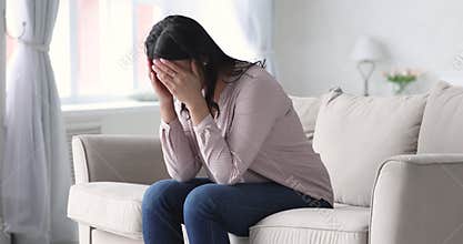 Depressed african woman suffer from stress sit alone at home