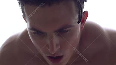 Young man boxing indoors light background sport concept breathing hard