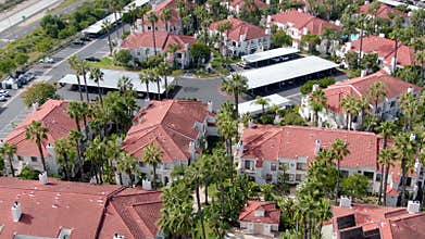 Aerial view of typical Southern California Spanish style residential condo with swimming pool