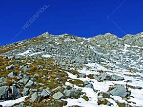 Alpine peak Falknis in the Ratikon border mountain massif or Raetikon Grenzmassiv and over the river Rhine valley Rheintal