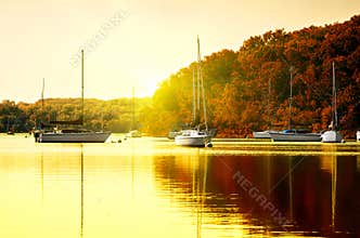 Sailboats on lake at sunset