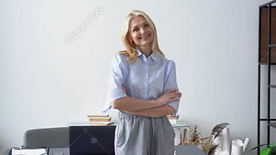 Smiling confident stylish 50s middle aged woman standing in office.