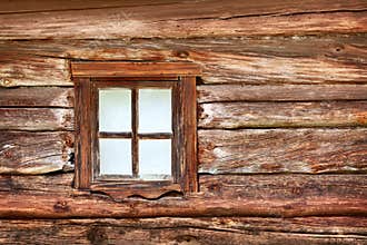 Small window in the old wooden wall