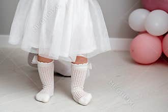 Little girl is learning to walk. Baby's first birthday. elegant baby