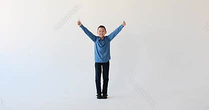 Asian boy showing thumbs up in approval on white background
