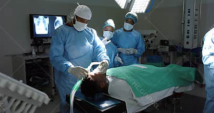 Diverse surgeons giving anesthesia to patient in operating theatre, slow motion