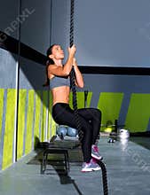 Crossfit rope climb exercise in fitness gym