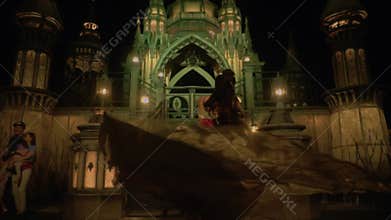 A Prince Spins His Princess in a Romantic Dance in Front of a Castle.