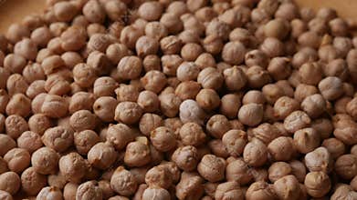 Raw Chickpeas on a rustic wooden table. Dry chickpea background close up. Chickpea legumes seed background.