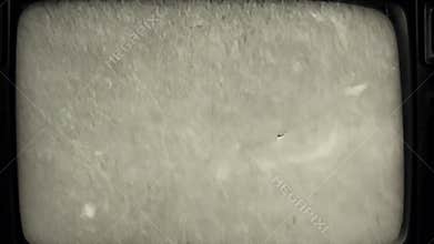 Faint vertical scratches and dust specks over a silent film–style black-and-white static, with subtle frame jitter