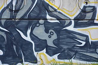 Graffiti depicting the word MAM on white, gray concrete fence.
